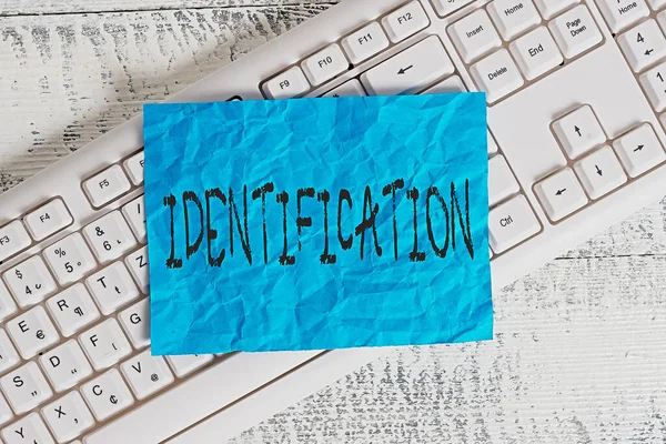 Text sign showing Identification. Conceptual photo an action or procedure to identify someone or something White keyboard office supplies empty rectangle shaped paper reminder wood. — Stock Photo, Image