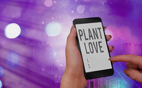 Texto de escritura de palabras Plant Love. Concepto de negocio para un símbolo de amor emocional, cuidado y apoyo mostrado a los demás Gadgets modernos con pantalla blanca bajo fondo bokeh colorido . — Foto de Stock