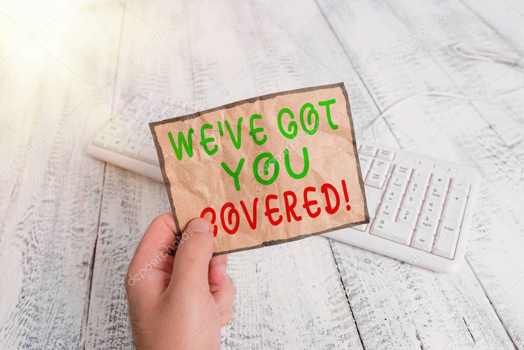 Conceptual hand writing showing Weve Got You Covered. Business photo text to have done gotten or provided whatever is needed Man holding colorful reminder square shaped paper wood floor.