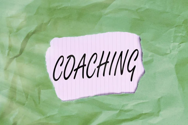 Writing note showing Coaching. Business photo showcasing unlocking an individuals potential to maximize their own performance Green crumpled colored paper sheet torn colorful background. — Stock Photo, Image