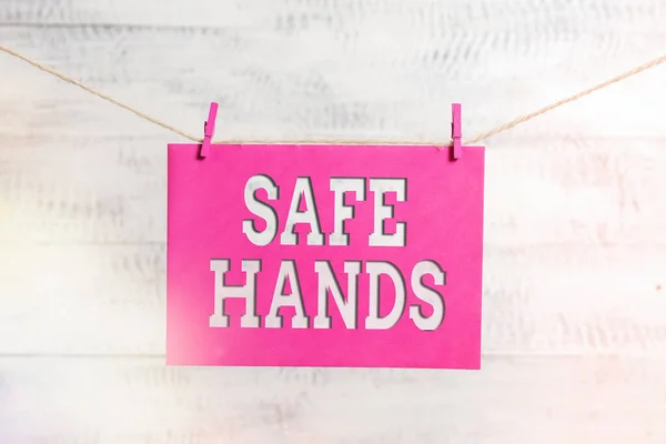 Word writing text Safe Hands. Business concept for Ensuring the sterility and cleanliness of the hands for decontamination Clothesline clothespin rectangle shaped paper reminder white wood desk. — Stock Photo, Image