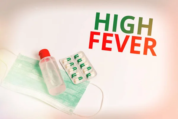Handwriting text High Fever. Concept meaning medical condition which the body temperature higher than usual Primary medical precautionary equipments for health care protection.