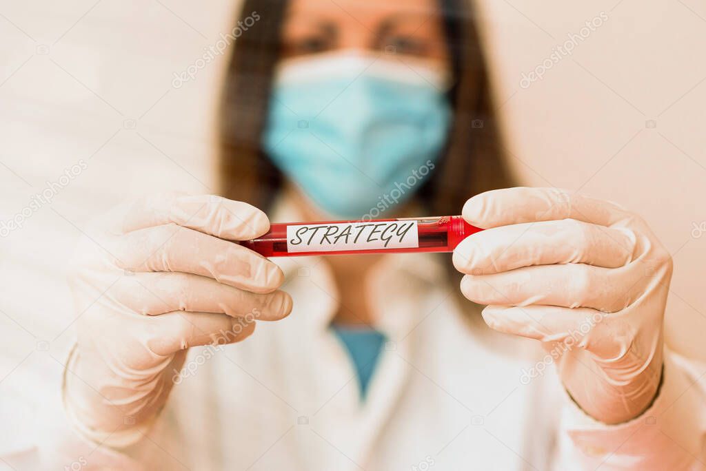 Writing note showing Strategy. Business photo showcasing action plan or strategy designed to achieve an overall goal Laboratory blood test sample for medical diagnostic analysis.