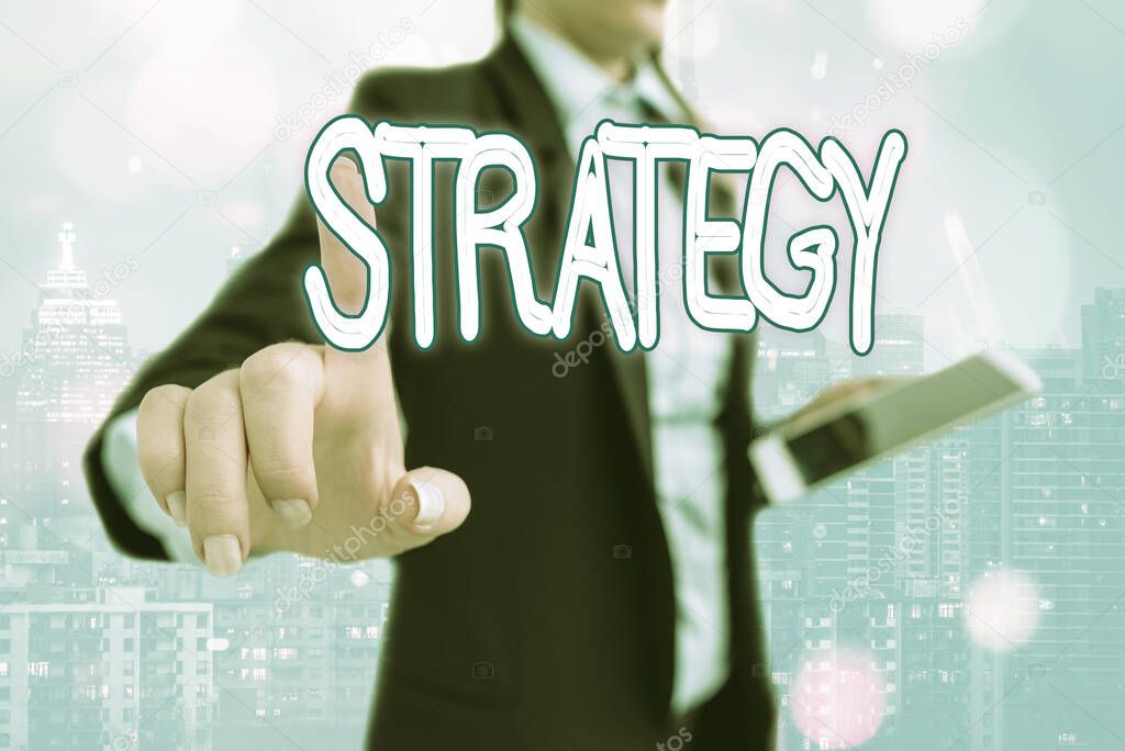 Writing note showing Strategy. Business photo showcasing action plan or strategy designed to achieve an overall goal Touch screen digital marking important details in business.