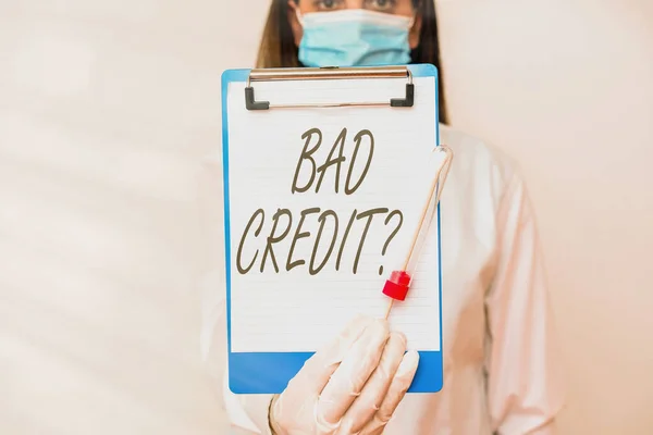 Handwriting text Bad Credit Question. Concept meaning a bad credit score due to nonpayment of loans Laboratory blood test sample shown for medical diagnostic analysis result.