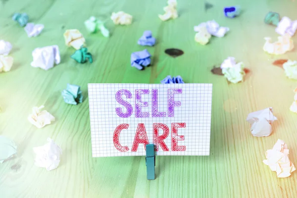 Writing note showing Self Care. Business photo showcasing the practice of taking action to preserve or improve one s is health Colored crumpled rectangle shaped reminder paper light blue background. — Stock Photo, Image