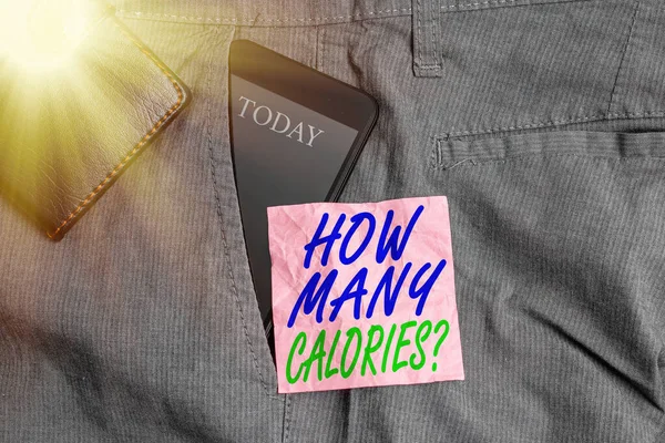 Text sign showing How Many Calories Question. Conceptual photo asking how much energy our body could get from it Smartphone device inside trousers front pocket with wallet and note paper.