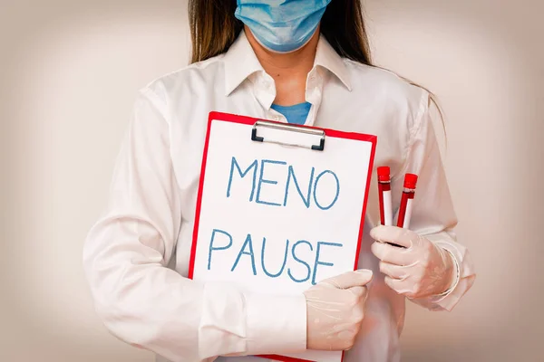 Handwriting text writing Meno Pause. Concept meaning the process through which a ceases to be fertile or menstruate Laboratory blood test sample shown for medical diagnostic analysis result.