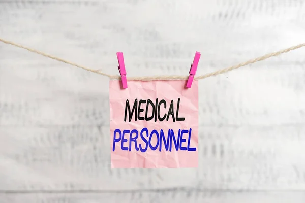 Conceptual hand writing showing Medical Personnel. Business photo showcasing trusted healthcare service provider allowed to treat illness Clothespin rectangle shaped paper reminder white wood desk.