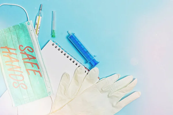 Conceptual hand writing showing Safe Hands. Business photo showcasing Ensuring the sterility and cleanliness of the hands for decontamination Set of medical equipment with notepad for health