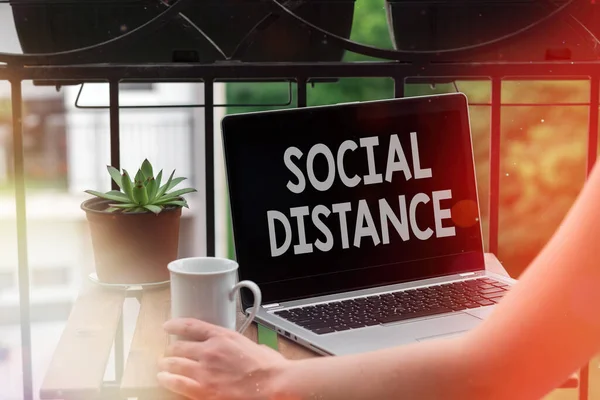 Text sign showing Social Distance. Conceptual photo maintaining a high interval physical distance for public health safety Personal workplace overview with laptop device used for individual interest.