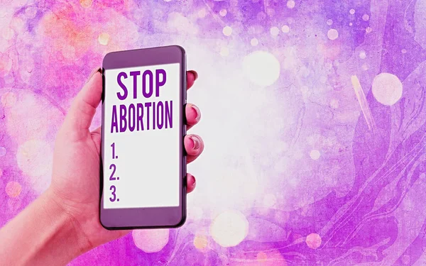 Sinal de texto mostrando Stop Abortion. Foto conceitual defendendo contra a prática do aborto Movimento Prolife gadgets modernos com tela de exibição branca sob fundo bokeh colorido . — Fotografia de Stock