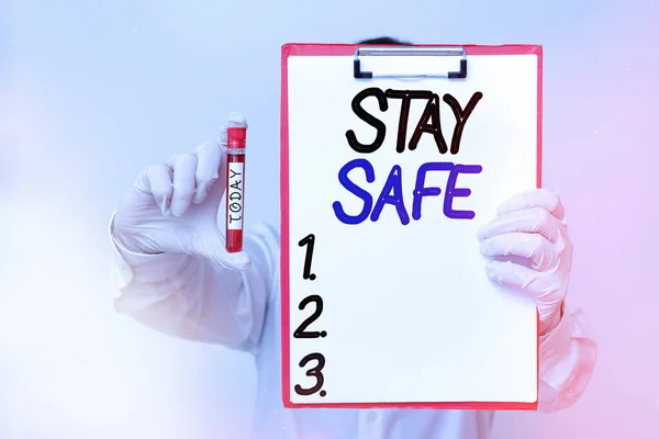 Conceptual hand writing showing Stay Safe. Business photo text secure from threat of danger, harm or place to keep articles Laboratory blood test sample for medical diagnostic analysis.