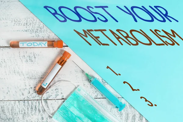 Handwriting text writing Boost Your Metabolism. Concept meaning body process uses to make and burn energy from food Extracted blood sample vial with medical accessories ready for examination.