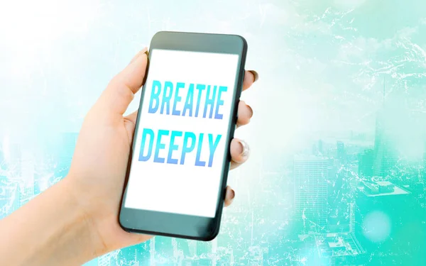 Conceptual hand writing showing Breathe Deeply. Business photo text to take a lot of air into the lungs inhaleexhale fully Modern gadgets white screen under colorful bokeh background.