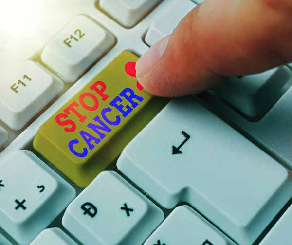 Handwriting text Stop Cancer. Concept meaning prevent the uncontrolled growth of abnormal cells in the body White pc keyboard with empty note paper above white key copy space. — Stock Photo, Image