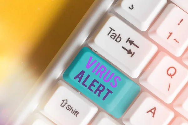 Text sign showing Virus Alert. Conceptual photo a quick to notice any unusual and potentially dangerous White pc keyboard with empty note paper above white key copy space.