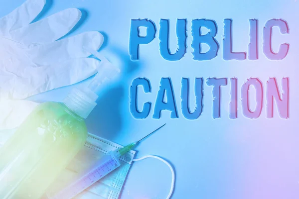 Conceptual hand writing showing Public Caution. Business photo showcasing formal warning given to the public to express a potential risk Primary medical precautionary equipments health protection. — Stock Photo, Image