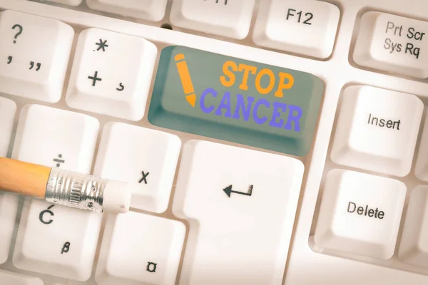 Conceptual hand writing showing Stop Cancer. Business photo text prevent the uncontrolled growth of abnormal cells in the body White pc keyboard with empty note paper above white key copy space. — Stock Photo, Image