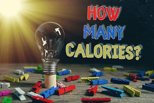 Conceptual hand writing showing How Many Calories Question. Business photo text asking how much energy our body could get from it Realistic colored vintage light bulbs, idea sign solution.