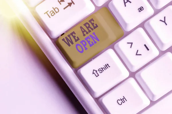 Text sign showing We Are Open. Conceptual photo no enclosing or confining barrier, accessible on all sides White pc keyboard with empty note paper above white key copy space. — Stock Photo, Image