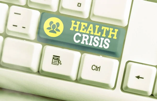 Text sign showing Health Crisis. Conceptual photo fitness problem that affects in more geographic areas White pc keyboard with empty note paper above white key copy space.