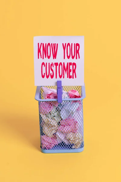 Conceptual hand writing showing Know Your Customer. Business photo text The idea of business identification and finance safety Trash bin crumpled paper clothespin office supplies yellow.