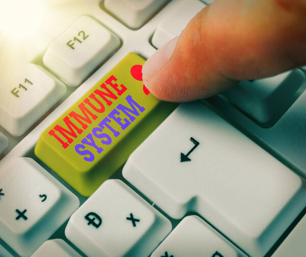 Handwriting text Immune System. Concept meaning Complex network work together to defend against germs White pc keyboard with empty note paper above white key copy space.