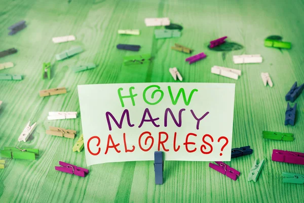 Conceptual hand writing showing How Many Calories Question. Business photo showcasing asking how much energy our body could get from it Colored crumpled rectangle shape paper light blue background. — Stock Photo, Image