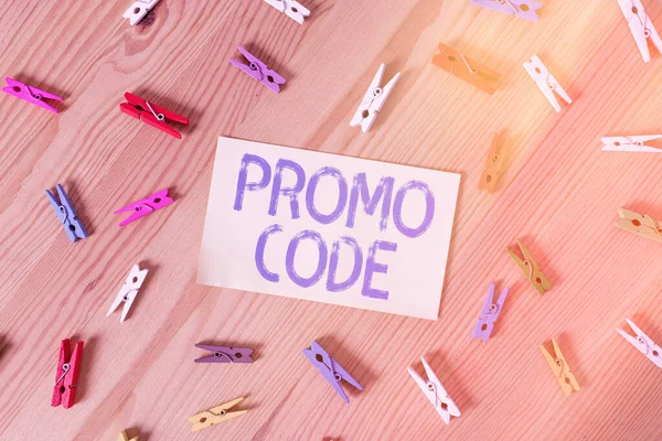 Handwriting text Promo Code. Concept meaning letters or numbers that allows getting a discount on something Colored clothespin papers empty reminder wooden floor background office. — Stock Photo, Image