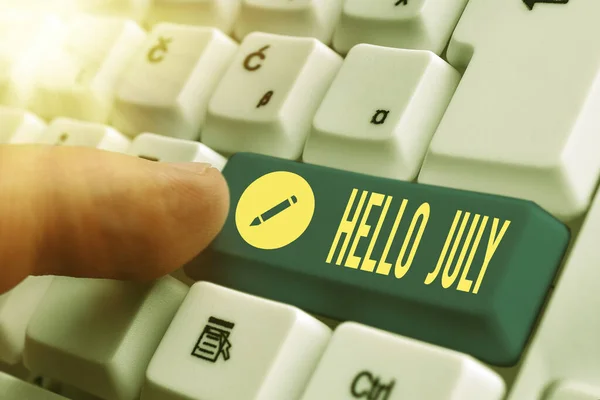 Writing note showing Hello July. Business photo showcasing expression of excitement for the coming holiday month of vacation White pc keyboard with empty note paper above white key copy space.