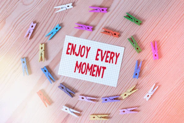 Text sign showing Enjoy Every Moment. Conceptual photo stay positive thinking for an individualal development Colored clothespin papers empty reminder wooden floor background office. — Stock Photo, Image