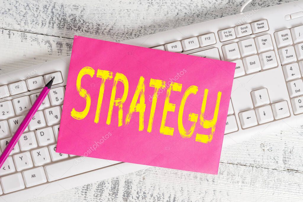 Handwriting text writing Strategy. Concept meaning action plan or strategy designed to achieve an overall goal White keyboard office supplies empty rectangle shaped paper reminder wood.