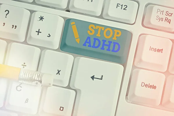 Conceptual hand writing showing Stop Adhd. Business photo text treat a disorder that affects the brain and behaviors of a child White pc keyboard with empty note paper above white key copy space.