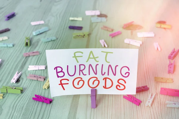 Conceptual hand writing showing Fat Burning Foods. Business photo showcasing produce fat loss by stimulating metabolism to reduce appetite Colored crumpled rectangle shape paper light blue background. — Stock Photo, Image