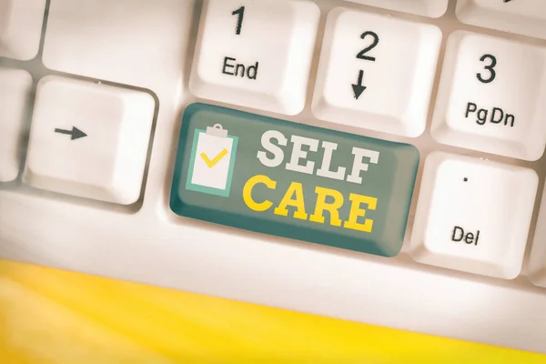 Writing note showing Self Care. Business photo showcasing the practice of taking action to preserve or improve one s is health White pc keyboard with empty note paper above white key copy space. — Stock Photo, Image