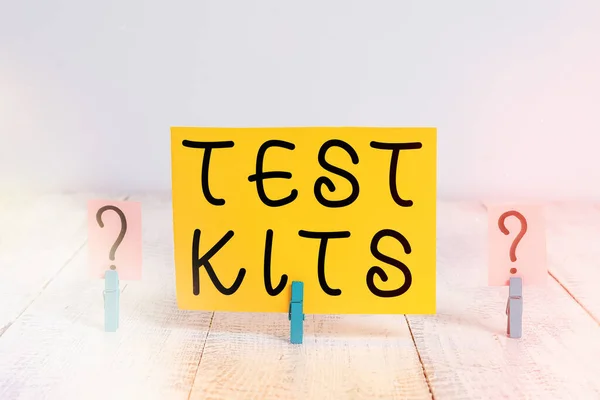Conceptual hand writing showing Test Kits. Business photo text tools used to detect the presence of something in the body Crumbling sheet with paper clips placed on the wooden table.