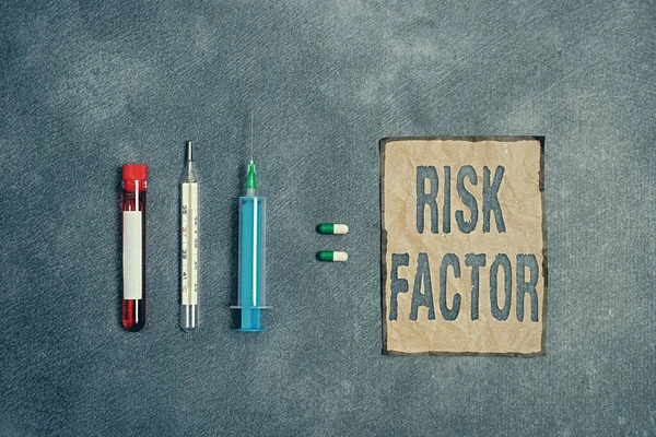 Writing note showing Risk Factor. Business photo showcasing Characteristic that may increase the percentage of acquiring a disease Blood sample vial medical accessories ready for examination.