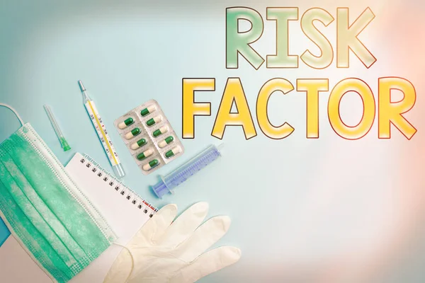 Writing note showing Risk Factor. Business photo showcasing Characteristic that may increase the percentage of acquiring a disease Set of medical equipment with notepad for health condition assessment