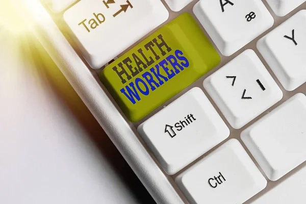 Text sign showing Health Workers. Conceptual photo showing whose job to protect the health of their communities White pc keyboard with empty note paper above white key copy space.