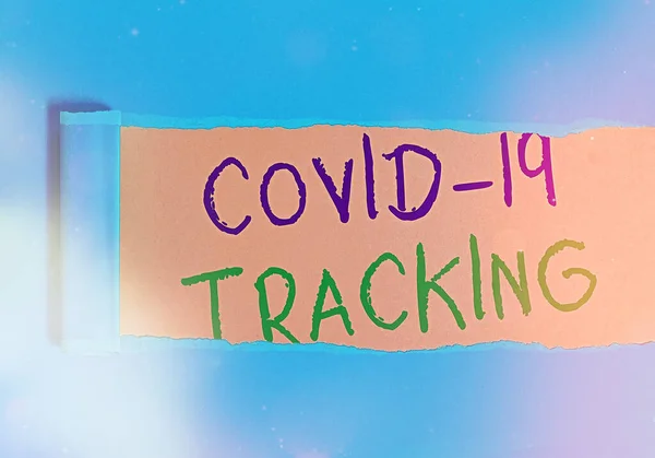 Handwriting text writing Covid 19 Tracking. Concept meaning Distinguishing process of the possible infected individuals Rolled ripped torn cardboard placed above a wooden classic table backdrop. — Stock Photo, Image