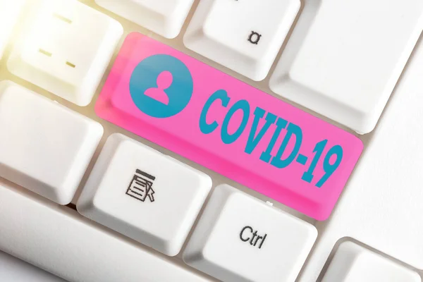 Handwriting text writing Covid19. Concept meaning mild to severe respiratory illness that is caused by a coronavirus White pc keyboard with empty note paper above white key copy space. — Stock Photo, Image