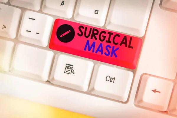 Writing note showing Surgical Mask. Business photo showcasing worn by health professionals during surgery and during nursing White pc keyboard with empty note paper above white key copy space.