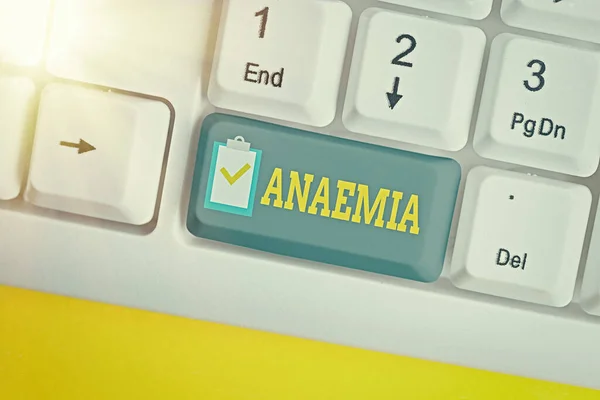 Writing note showing Anaemia. Business photo showcasing a condition marked by a deficiency of hemoglobin in the blood White pc keyboard with empty note paper above white key copy space.