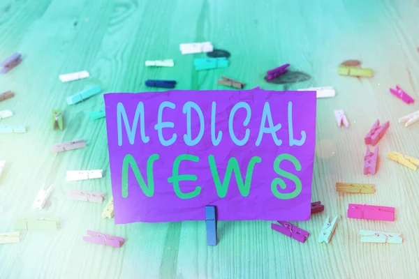 Handwriting text writing Medical News. Concept meaning report or noteworthy information on a medical breakthrough Colored crumpled rectangle shaped reminder paper light blue background.