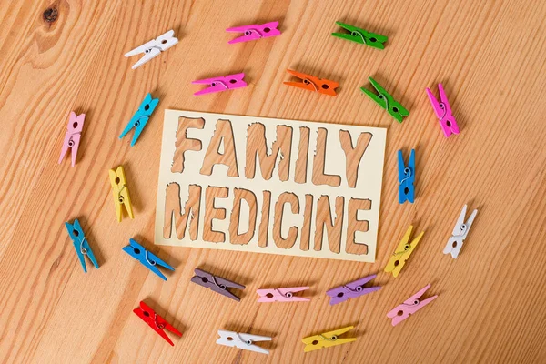 Text sign showing Family Medicine. Conceptual photo comprehensive health care for the individual and family Colored clothespin papers empty reminder wooden floor background office.