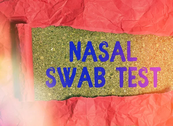 Conceptual hand writing showing Nasal Swab Test. Business photo text diagnosing an upper respiratory tract infection through nasal secretion Rolled ripped torn cardboard above a wooden classic table.