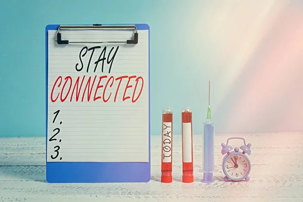 Text sign showing Stay Connected. Conceptual photo to remain having social professional commercial relationship Extracted blood sample vial with medical accessories ready for examination.