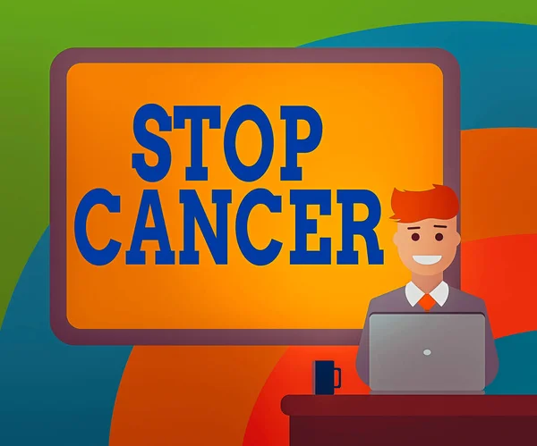 Conceptual hand writing showing Stop Cancer. Business photo showcasing prevent the uncontrolled growth of abnormal cells in the body Bordered Board behind Man Smiling with Laptop Mug on Desk. — Stock Photo, Image
