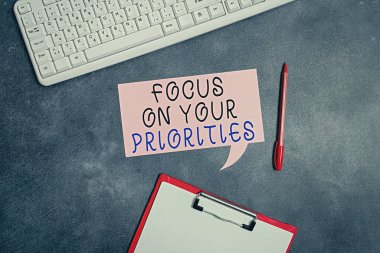 Conceptual hand writing showing Focus On Your Priorities. Business photo text remove distractions Have a life plan Be a fortress Paper accessories with smartphone arranged on different background. clipart